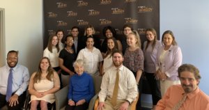 Eleanor Clift with RespectAbility staff and Summer 2019 Fellows smiling in front of the RespectAbility banner