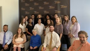 Eleanor Clift with RespectAbility staff and Summer 2019 Fellows smiling in front of the RespectAbility banner