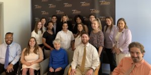 Eleanor Clift with RespectAbility staff and Summer 2019 Fellows smiling in front of the RespectAbility banner