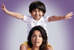 Gina Rodriguez as Jane The Virgin with her son Mateo (played by Elias Janssen) on her back