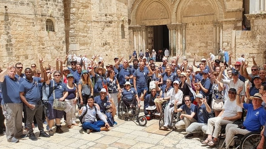 Attendees at Access Israel's conference together outside the Holy site in Jerusalem, many of them wheelchair users.
