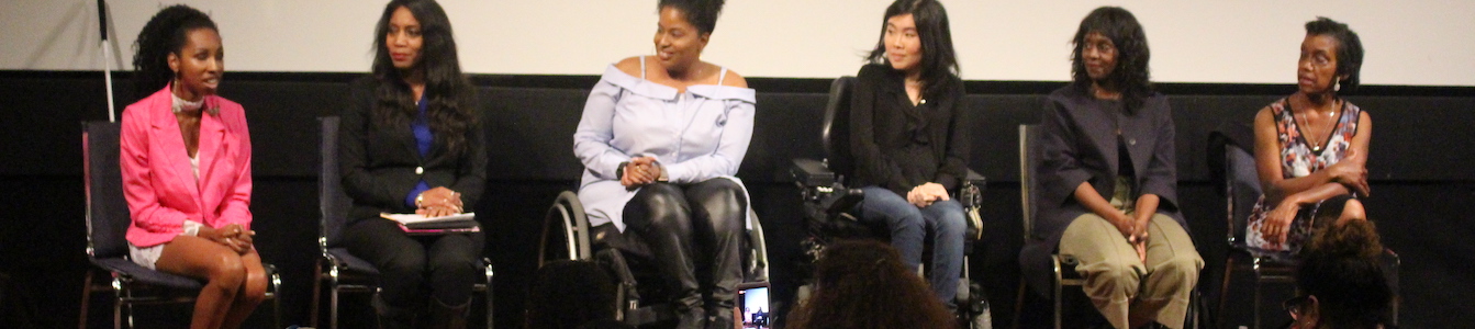 Six women of color with disabilities at the Women of Color Disability Summit on stage together in the middle of a discussion