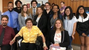 Judy Heumann with RespectAbility summer 2019 fellows inside the Cleveland park library, smiling