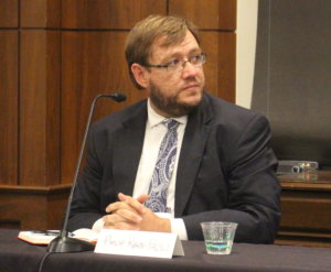 Philip Kahn-Pauli sitting behind a table, participating in RespectAbility's final panel of the 2019 Summit