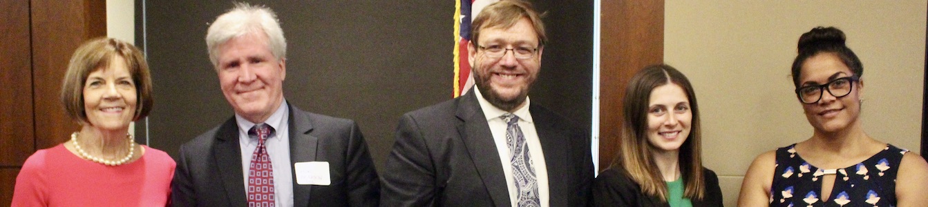 Policy panelists smiling together in front of an American flag at RespectAbility's 2019 summit