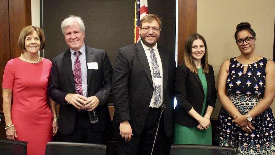 Policy panelists smiling together in front of an American flag at RespectAbility's 2019 summit