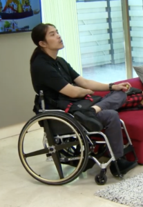 Pao, who is a wheelchair user, inside a living room on The Real World Thailand