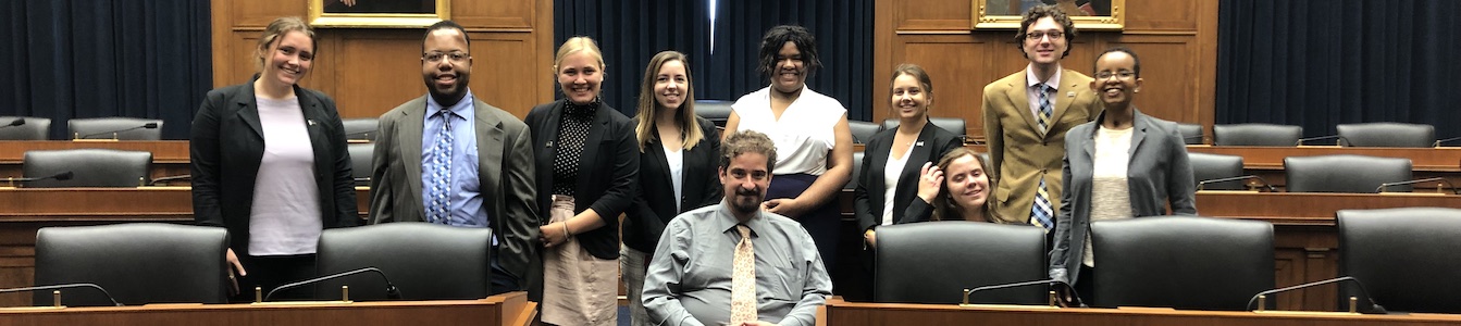 RespectAbility Summer 2019 Fellows smile together inside a Capitol Hill hearing room