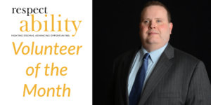 Gary Norman smiling wearing a suit and tie in front of a black background Text: RespectAbility Volunteer of the Month.