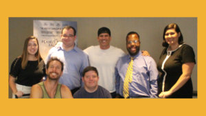 Jolie Carr with RespectAbility team members and the directors and star of the Peanut Butter Falcon in front of a poster for the movie