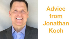 Jonathan Koch smiling wearing a suit in front of a grey backdrop. Text: Advice from Jonathan Koch