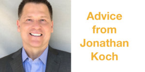 Jonathan Koch smiling wearing a suit in front of a grey backdrop. Text: Advice from Jonathan Koch