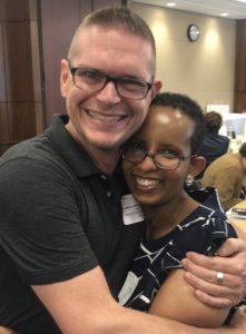 Laka Mitiku Negassa hugs a man who helped her recover from her brain injury at RespectAbility's 2019 summit