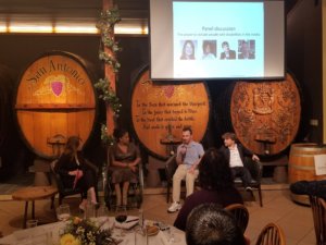 Four panelists sitting and speaking as part of a discussion on the power to include people with disabilities in the media.