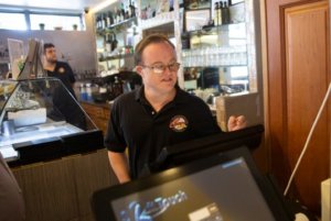 Cosmos Ristorante & Pizzeria employee Shawn Denton clocks in before the start of his work shift, Thursday, Sept. 19, 2019 in Naples.