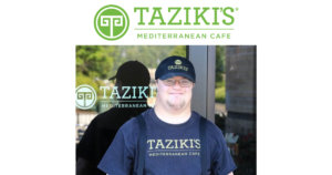 A worker with a disability standing outside Taziki's Mediterranean Cafe wearing a hat and shirt with the restaurant's logo on it. Taziki's Mediterranean Cafe logo.