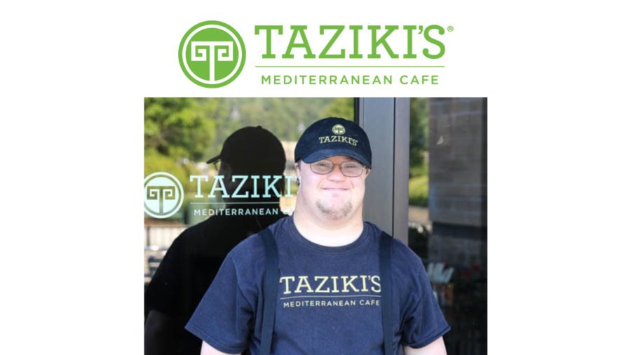 A worker with a disability standing outside Taziki's Mediterranean Cafe wearing a hat and shirt with the restaurant's logo on it. Taziki's Mediterranean Cafe logo.