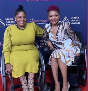 two African American women wearing dresses seated in wheelchairs