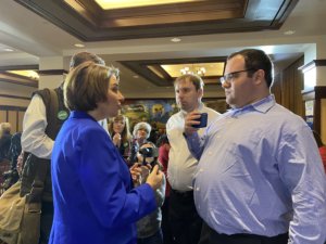 Eric Ascher filming Amy Klobuchar giving an answer on disability issues while James Trout looks on