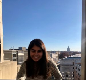 Sneha smiling with the US capitol in the background