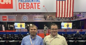 James Trout and Eric Ascher smile inside the spin room at the CNN Democratic Debate