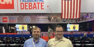 James Trout and Eric Ascher smile inside the spin room at the CNN Democratic Debate