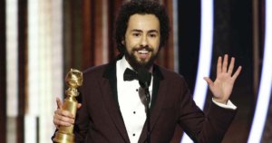 Ramy Youssef on stage at the 77th Annual Golden Globes Award speaking with his award for Best Actor in his hand