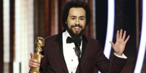 Ramy Youssef on stage at the 77th Annual Golden Globes Award speaking with his award for Best Actor in his hand