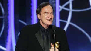Quentin Tarantino accepts his award for Best Screenplay on stage at the Golden Globes
