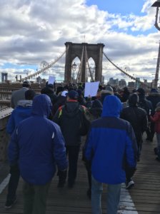 Rally participants march across the Brooklyn bridge together