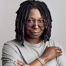 Whoopi Goldberg headshot wearing a gray sweater