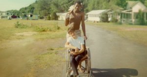 Neil Jacobson, sitting in a manual wheelchair, and Alan Ford at Camp Jened in 1968