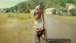 Neil Jacobson, sitting in a manual wheelchair, and Alan Ford at Camp Jened in 1968