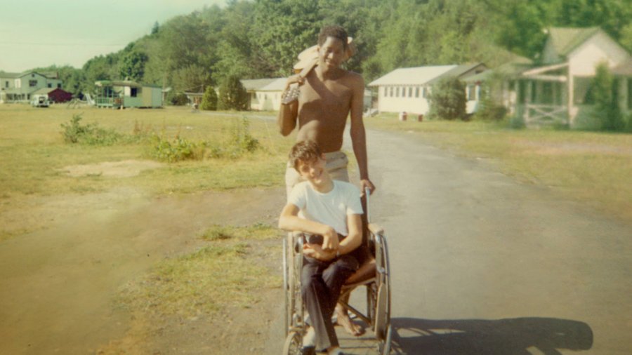 Neil Jacobson, sitting in a manual wheelchair, and Alan Ford at Camp Jened in 1968