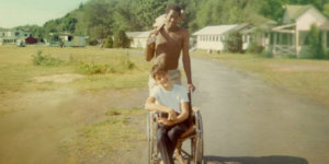 Neil Jacobson, sitting in a manual wheelchair, and Alan Ford at Camp Jened in 1968