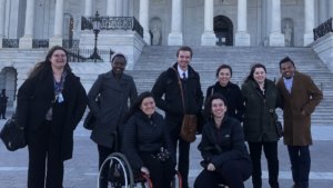 RespectAbility Fellows with disabilities and allies smile together in front of the U.S. Capitol building steps