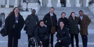 RespectAbility Fellows with disabilities and allies smile together in front of the U.S. Capitol building steps