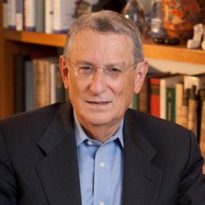 Stan Greenberg smiling headshot in front of a bookshelf