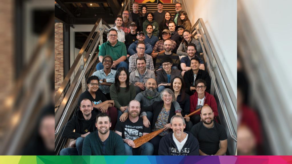 The team behind Pixar's Loop sitting on a staircase smiling