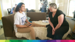 Voice actress Madison Blandy with Director Erica Milsom seated in Blandy's living room on chairs, talking