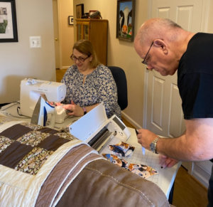 Tonya Koslo and her husband Tim making masks in her house