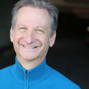 Headshot of David Zimmerman wearing a blue jacket smiling