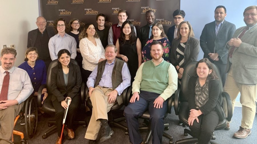 Steve Bartlett with RespectAbility Staff and Spring 2020 Fellows smiling in front of the RespectAbility banner