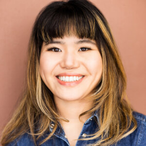 Ava Rigelhaupt smiling headshot wearing a blue denim jacket