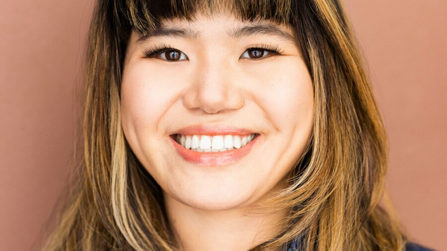 Ava Rigelhaupt smiling headshot wearing a blue denim jacket