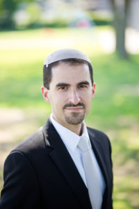 Elie Klein headshot wearing a suit and tie