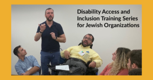 A man using a wheelchair next to an ASL interpreter speaks as three other people look on seated. Text: Disability Access and Inclusion Training Series for Jewish Organizations