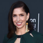 Shoshannah Stern smiling in front of a sign for the College Television Awards