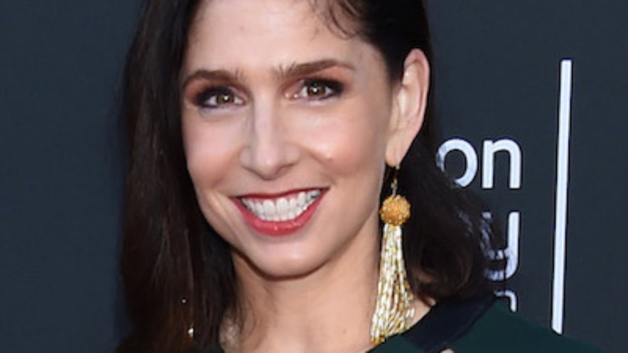 Shoshannah Stern smiling in front of a sign for the College Television Awards