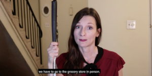 Still from the SNAP Delivery Saves Lives PSA video with a blind woman holding a white cane talking to camera. Subtitle Text: we have to go to the grocery store in person